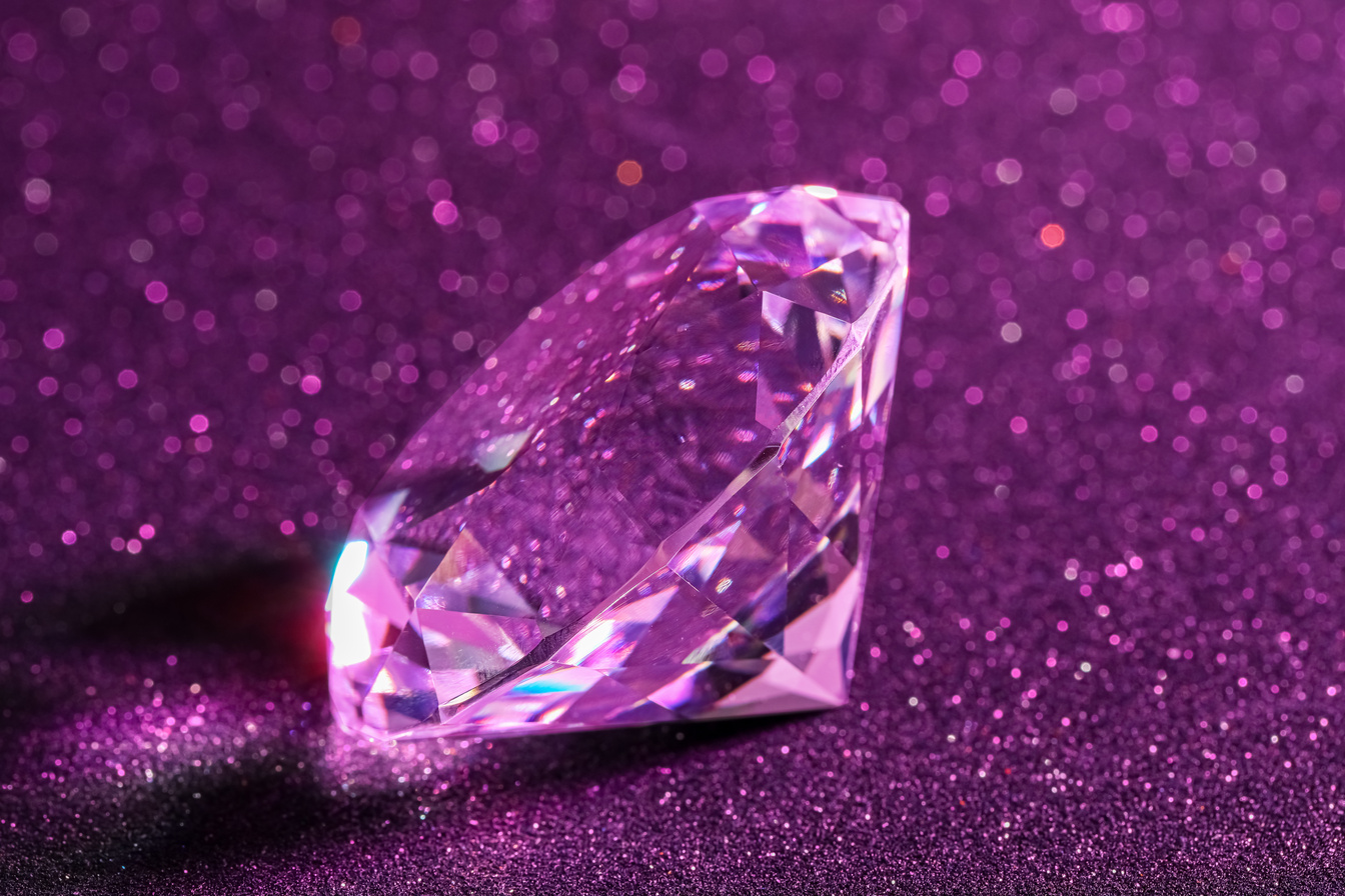 Beautiful Shiny Diamond on Purple Glitter Background, Closeup
